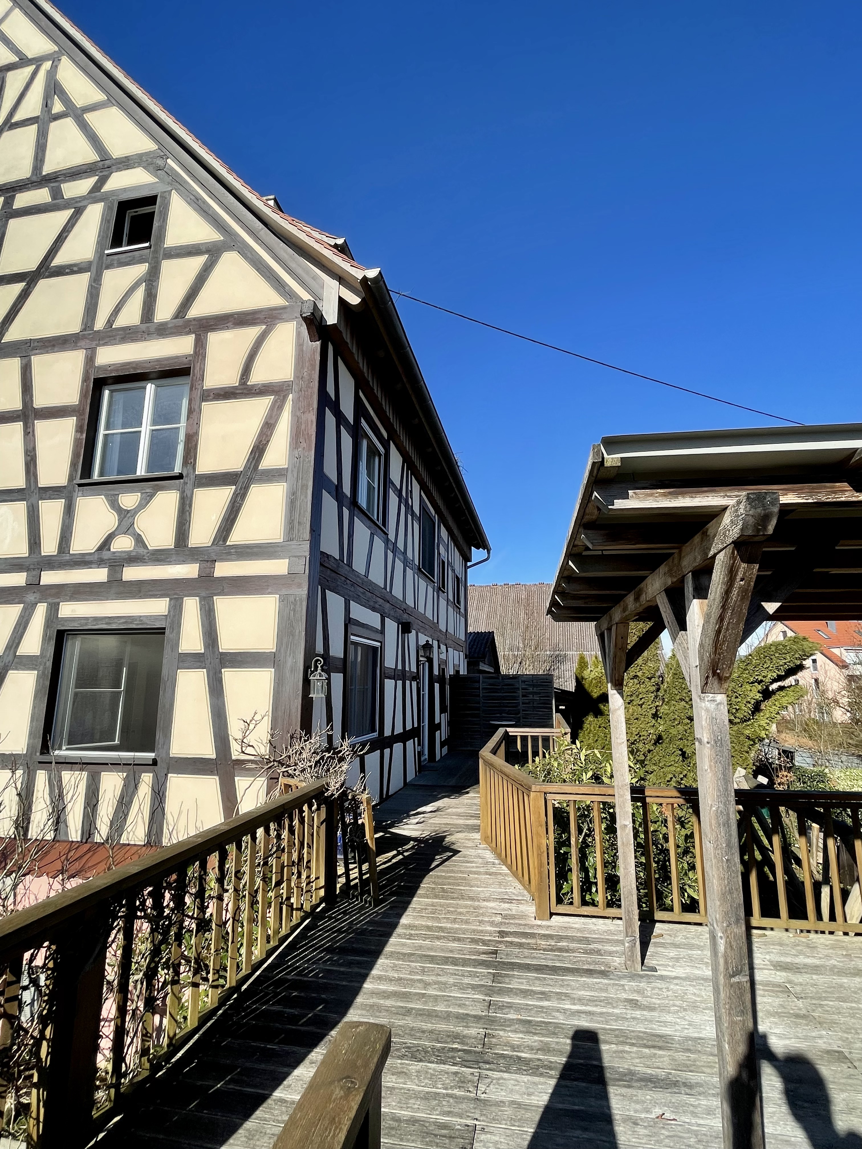 Half-timbered exterior walkway of Villa Salem leading to the shared deck
