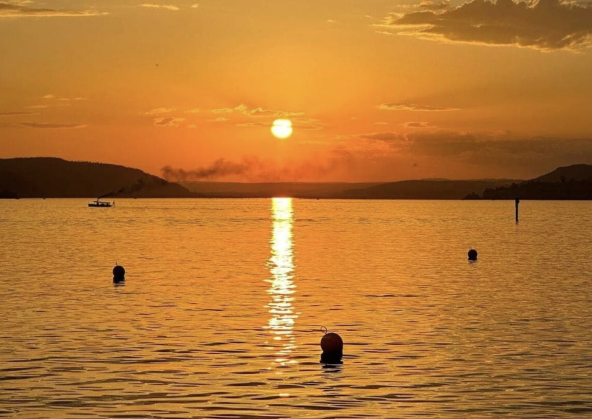 Warm sunset over Lake Constance with golden reflections on the water