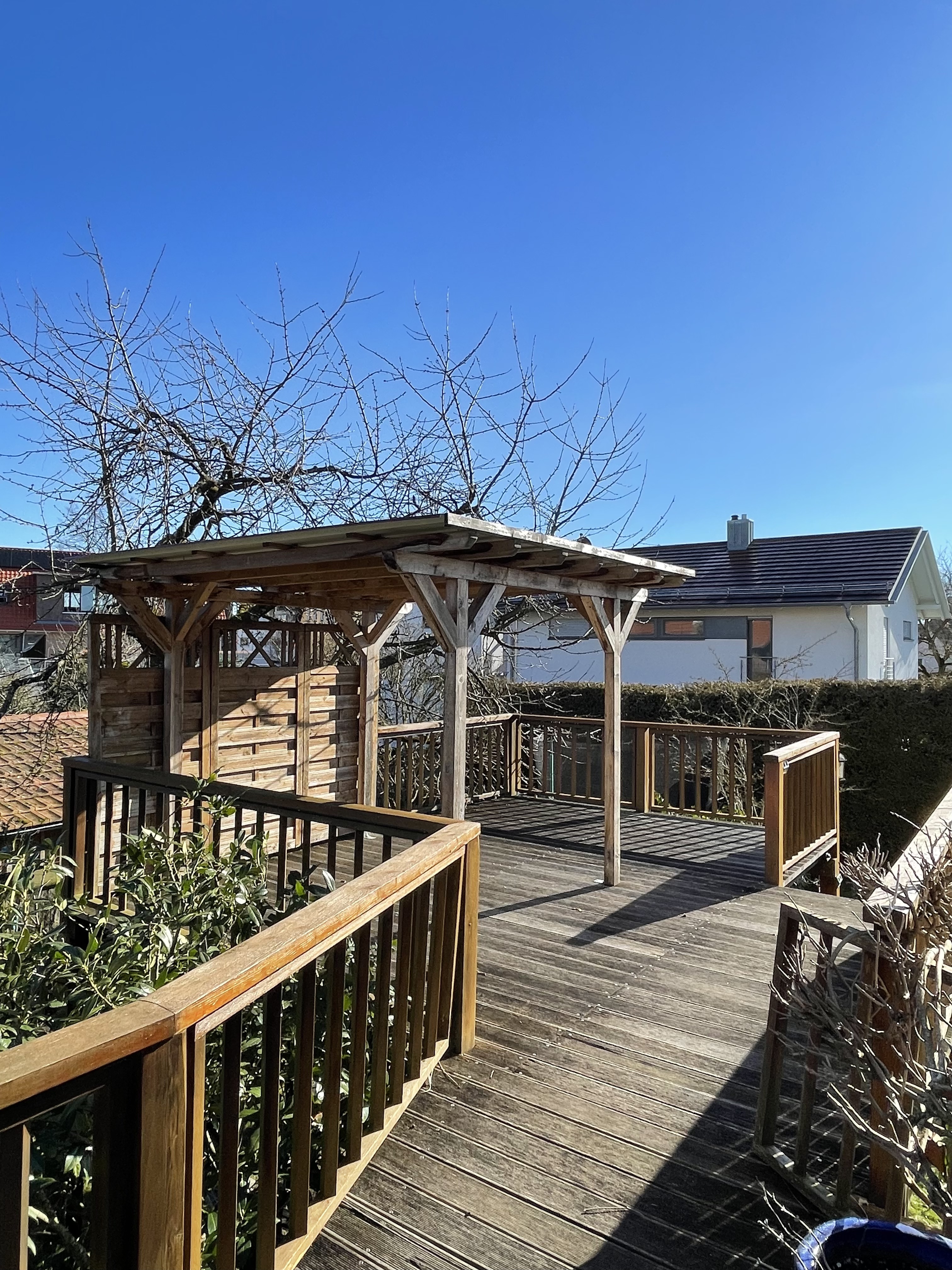Shared garden deck and pergola at Villa Salem under blue sky