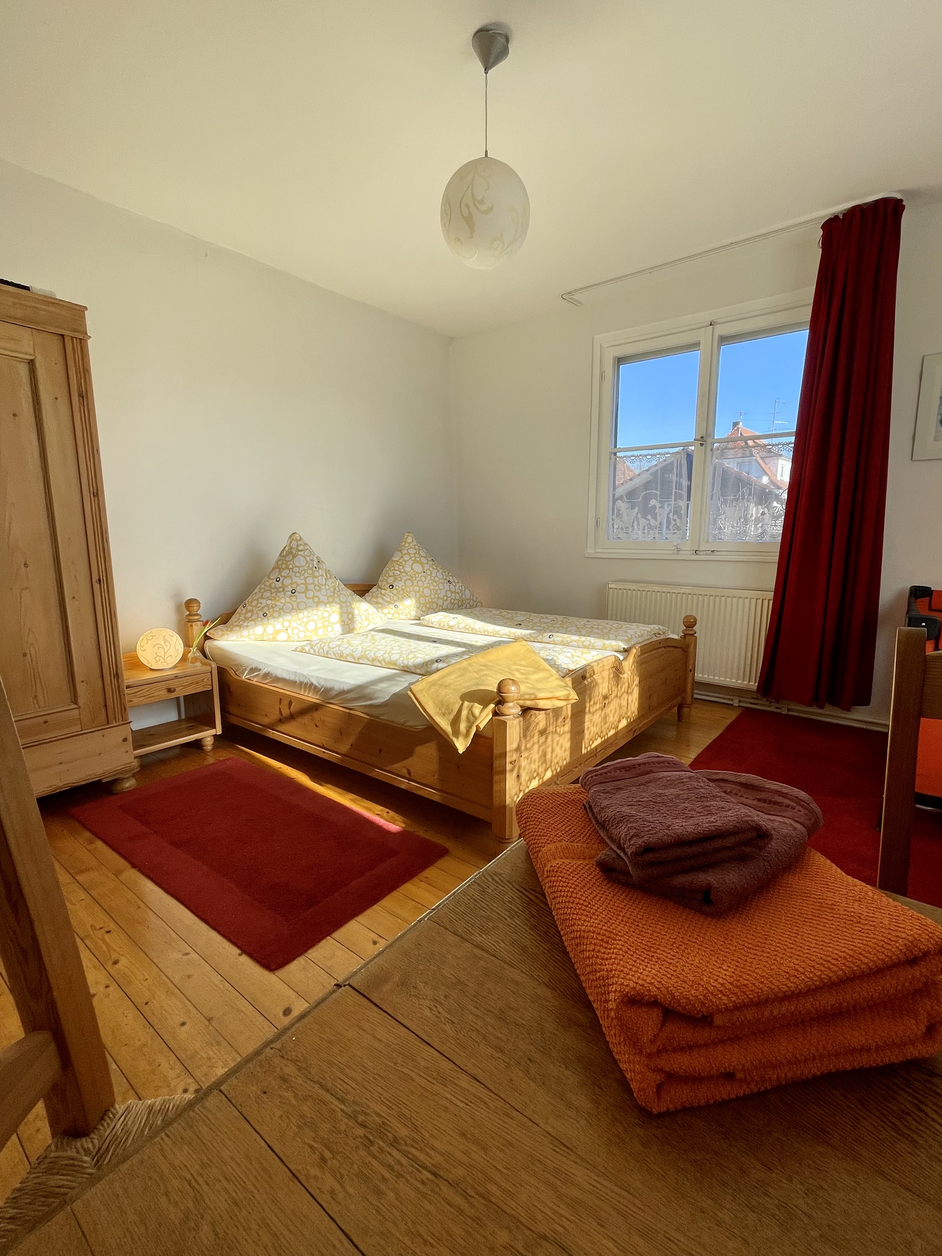 Main bedroom with double bed and warm morning light