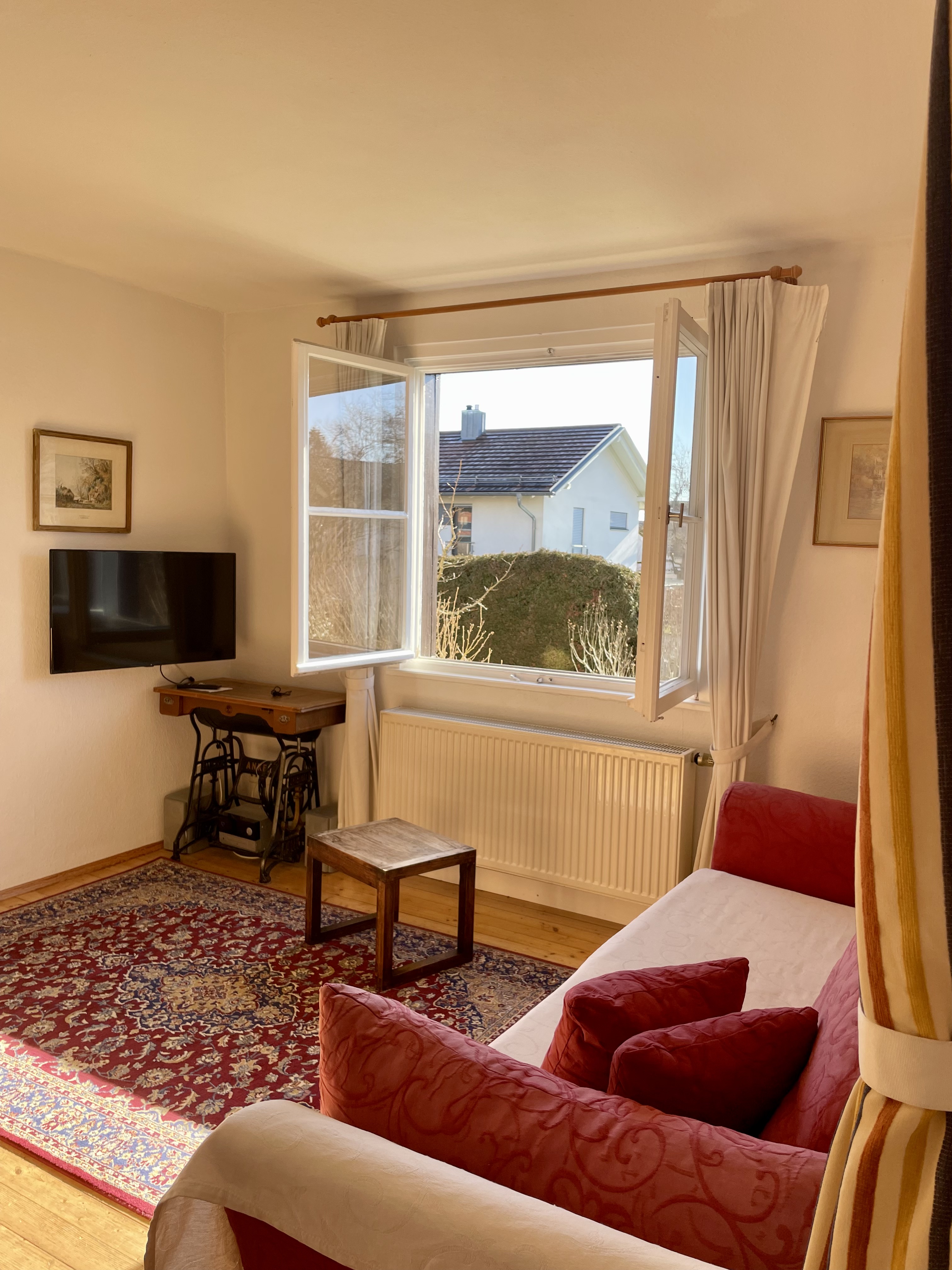 Warm living room with sofa, dining table and bright window